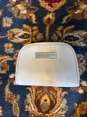 Molton Cream Cosmetic Pouch with Silver Logo Plaque